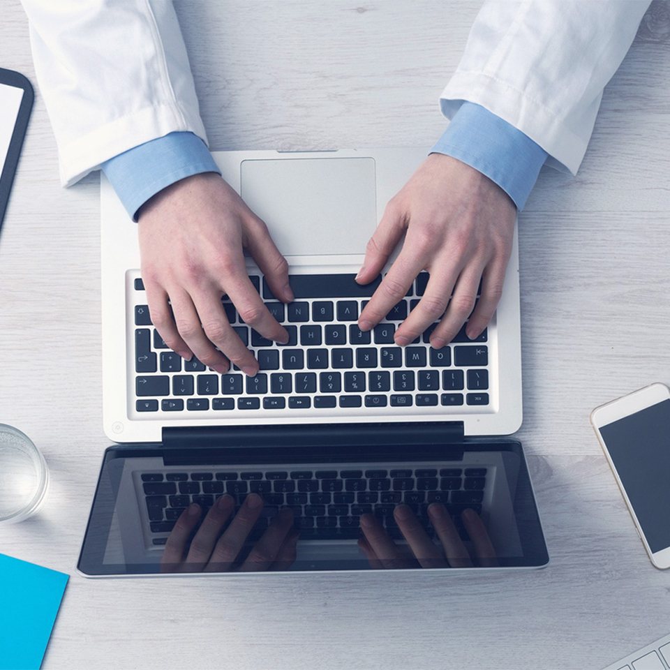 Person typing on a laptop computer at a desk