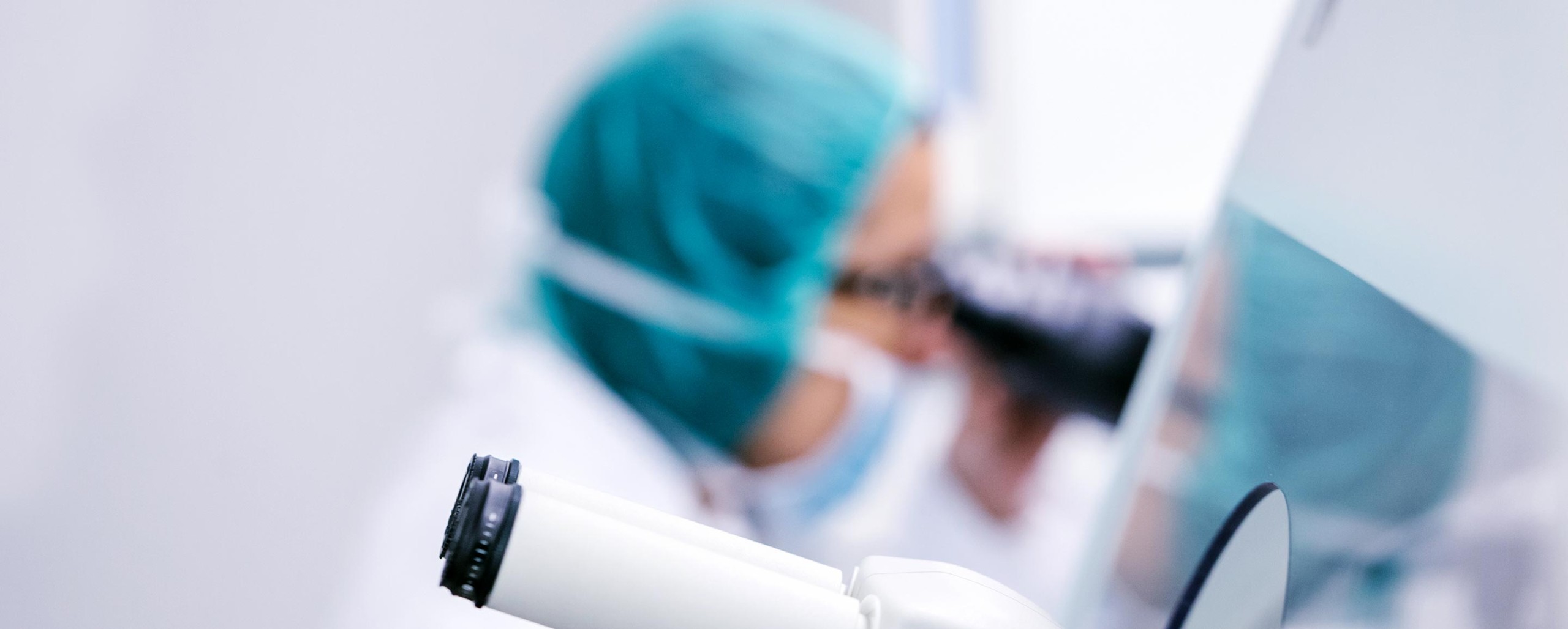 Medical professional in surgical cap and mask working with documents or medical records
